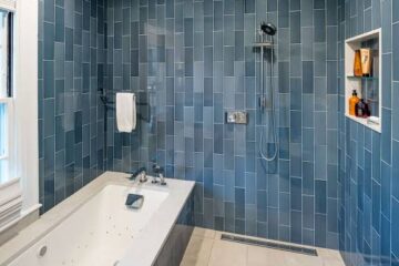 Water leaking through cracked shower curb and damaged grout