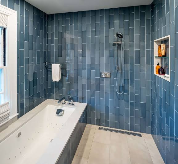 Water leaking through cracked shower curb and damaged grout